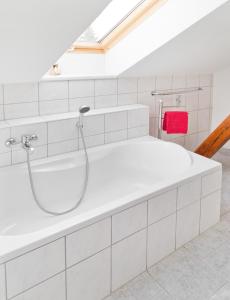 a white bathroom with a shower and a tub at Pension Hanna in Bad Wilsnack +9 photos