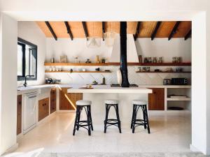 a kitchen with a island and two stools at The Goathouse in Larnaca