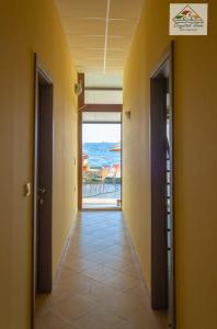 a hallway leading to a room with a view of the ocean at Crystal View - Elsa's Apartments in Kavála