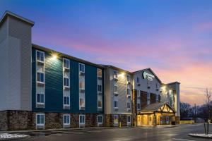 a rendering of a hotel at dusk at WoodSpring Suites Indianapolis Airport South in Indianapolis
