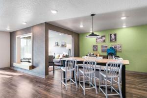 a kitchen and dining room with a table and chairs at WoodSpring Suites Davenport FL in Davenport