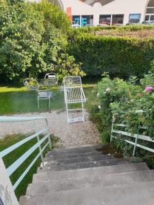 a group of chairs and tables sitting on some stairs at L'AUBERGADE in Vittel +12 photos