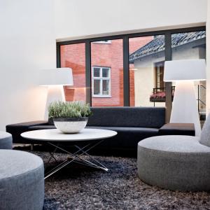 a living room with a couch and chairs and a table at Thon Hotel Panorama in Oslo