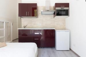 a small kitchen with a sink and a refrigerator at Alessia's Flat - Certosa in Milan