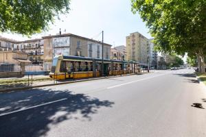 a bus is parked on the side of a street at Alessia's Flat - Certosa in Milan