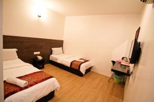 En eller flere senge i et værelse på Hotel Rasah Seremban