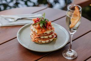 a stack of pancakes on a plate next to a glass at Napa Plaza Hotel (Adults Only) in Ayia Napa