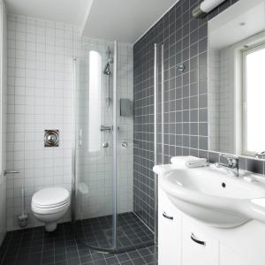 a bathroom with a toilet and a sink and a shower at Thon Hotel Panorama in Oslo