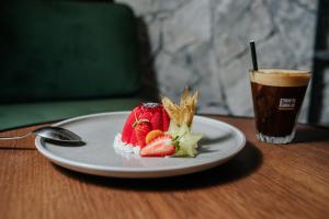 a plate of food and a drink on a table at Napa Plaza Hotel (Adults Only) in Ayia Napa