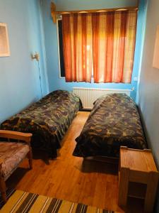 a room with two beds and a window in it at Majatalo Tyrni in Nakkila