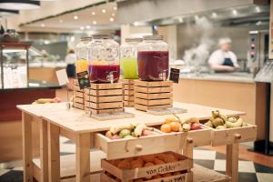 two mason jars of juice and fruit on a table at Van der Valk Theaterhotel Almelo in Almelo