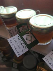 a display of jars of honey with labels on them at B&B Nereidi in Melito di Porto Salvo +19 photos