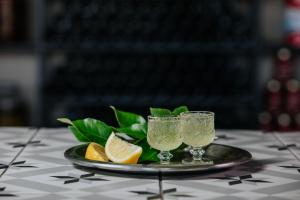 a plate with two glasses and lemons on a table at Napa Plaza Hotel (Adults Only) in Ayia Napa +37 photos