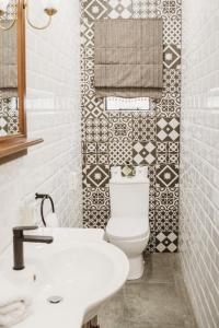 a bathroom with a white toilet and a sink at Iso'Bella Vita Guesthouse in Phalaborwa