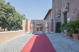 a red carpet on a brick road with a building at Il Monastero Collection in Rome