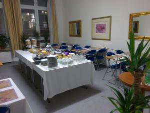 a room with a table with food on it at Willy Hotel Frankfurt in Frankfurt