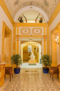 a large hallway with a statue in a building at Casa Rocca Piccola B&B in Valletta
