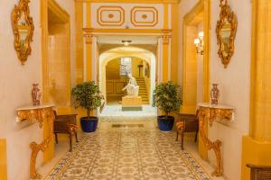 a hallway with a statue in the center of a building at Casa Rocca Piccola B&B in Valletta