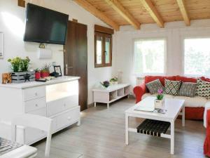 a living room with a couch and a tv at LA CASITA DEL JARDiN in Villaverde de Arriba +13 photos