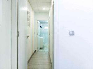 a hallway with a bathroom with a toilet and a sink at LA CASITA DEL JARDiN in Villaverde de Arriba