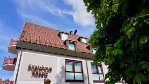 a building with a red roof on top of it at Gästehaus Rössle in Weinstadt