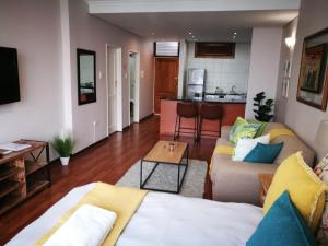 a living room with a couch and a table at 45 Lighthouse Mall Apartment in Durban