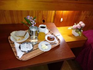 a tray of breakfast food on a wooden table at Hotel Ideal in Montecarlo