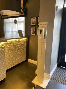 a room with a counter with a refrigerator in it at Best Western Victoria Palace in London