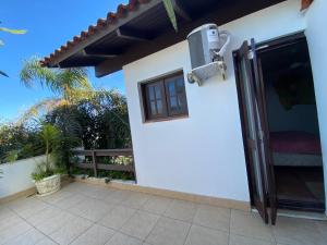 a view of the outside of a house with a patio at Pousada Morada Da Prainha in Torres