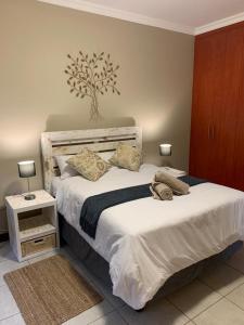 a bedroom with a large bed with white sheets and pillows at Bread & Barrel Eureka Kimberley in Kimberley