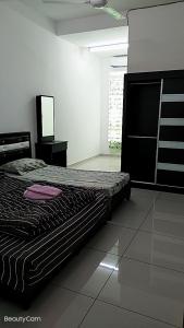 a bedroom with a bed and a mirror in it at FangFei Homestay in Seremban +22 photos