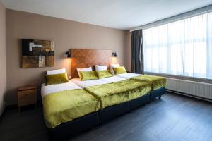 Postel nebo postele na pokoji v ubytování The Alfred Hotel