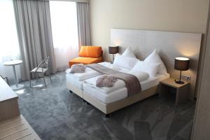 Postel nebo postele na pokoji v ubytování Garni Hotel Schmaus