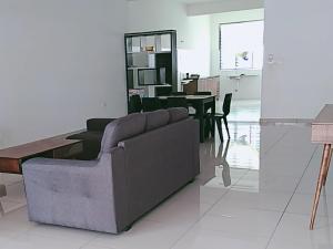 a living room with a couch and a table at FangFei Homestay in Seremban