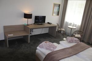 Postel nebo postele na pokoji v ubytování Garni Hotel Schmaus