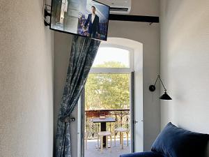 Habitación con ventana y TV en la pared. en Marinesko Apartments, en Odessa