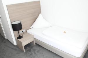 Postel nebo postele na pokoji v ubytování Garni Hotel Schmaus