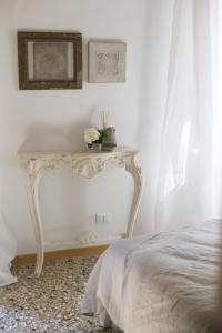 a white table with flowers on it in a bedroom at Laguna724 in Venice