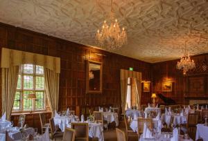 
a dining room filled with tables and chairs at Waterford Castle Hotel & Golf Resort in Waterford
