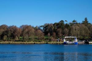 a large white boat floating on top of a body of water at Waterford Castle Hotel & Golf Resort in Waterford