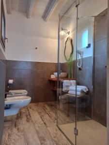 a bathroom with a glass shower and a sink at Le Zampolle B & B in Colà di Lazise