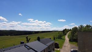 an overhead view of a house with a road and a field at Pension & Gasthof Erbgericht Höhenlage 850m in Marienberg +28 photos