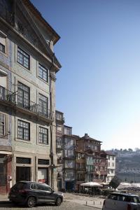 a car parked in front of a building at PortoSense Ribeira in Porto
