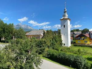 un pequeño pueblo con una iglesia y una torre en Villa Butterfly en Nová Lesná