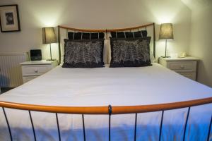 a large bed in a room with two night stands at Beachlands Hotel in Weston-super-Mare