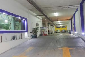 an empty parking garage with a yellow arrow on the wall at Hotel Rivoli in León