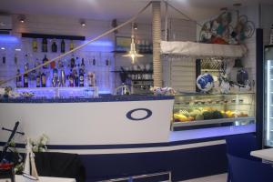 a bar in a restaurant with a counter with food at Miramare in Pozzallo