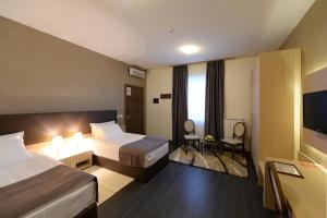 Postel nebo postele na pokoji v ubytování Hotel Majdan