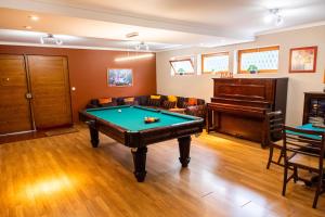 a living room with a pool table and a piano at Snooker House in Ponta Delgada