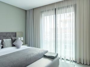 Ένα ή περισσότερα κρεβάτια σε δωμάτιο στο Makass Appart Hotel